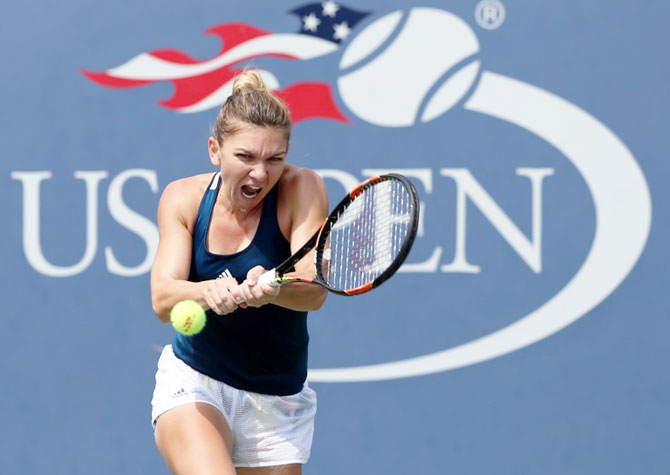 Simona Halep of Romania plays a forehand return against Carla Suarez Navarro of Spain 