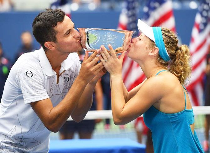 Laura Siegemund of Germany and Mate Pavic of Croatia celebrate with the US Open trophy after beating Coco Vandeweghe and Rajeev Ram of the United States in the mixed doubles final at USTA Billie Jean King National Tennis Center at Flushing Meadows in New York on Friday