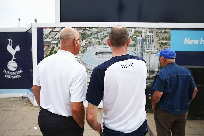  Tottenham Hotspur fans look at the building site for the new stadium