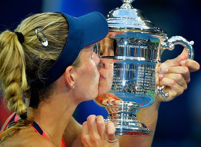 Angelique Kerber of Germany kisses the trophy after winning against Karolina Pliskova of the Czech Republic during the women's singles final of US Open at the USTA Billie Jean King National Tennis Center