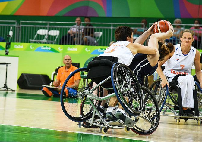 Roos Oosterbaan of Netherlands watches as her teammate Inge Huitzinge fights for the ball with Desiree Miller of United States during Women's Wheelchair Basketball match during Rio 2016 Paralympics at Carioca Arena 1 on Sunday, September 11