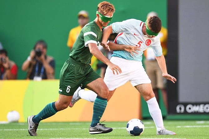 Tiago of Brazil (left) competes for the ball with Recep Aydeniz of Turkey (right) in the men's football 5-a-side on Sunday, September 11