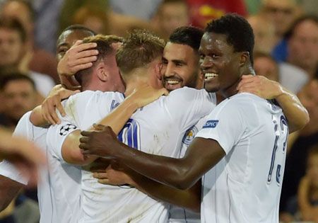 Leicester City's Riyad Mahrez celebrates with team mates after scoring 