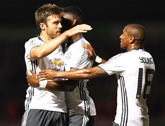 Manchester United's Michael Carrick celebrates with teammates after scoring against Northampton Town
