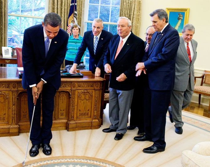 Barack Obama gets golfing lessons from Arnold Palmer in the Oval Office of the White House