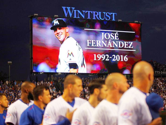 A moment of silence for Miami Marlins pitcher Jose Fernandez (16) with the Chicago Cubs in the foreground prior the first inning against the St. Louis Cardinals at Wrigley Field on Sunday