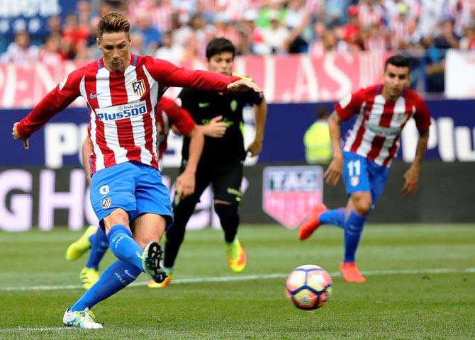 Atletico Madrid's Fernando Torres scores a goal from the penalty spot