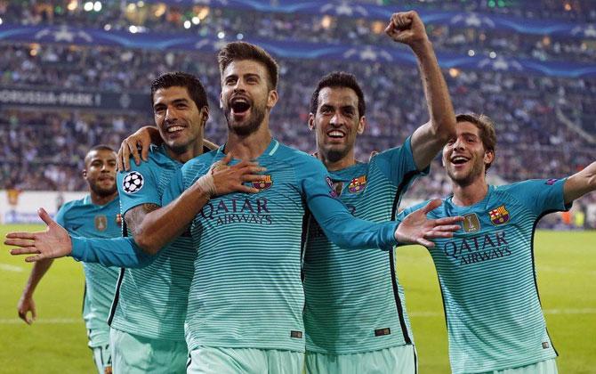 FC Barcelona's Gerard Pique celebrates after scoring the winning goal against Borussia Moenchengladbach during their UEFA Champions League match at the Borussia Park stadium in Moenchengladbach on Wednesday