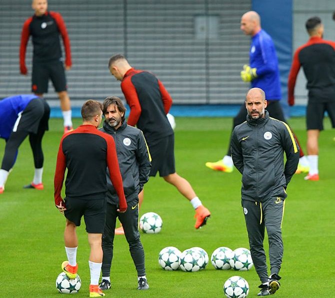 Pep Guardiola manager of Manchester City looks on during a training session