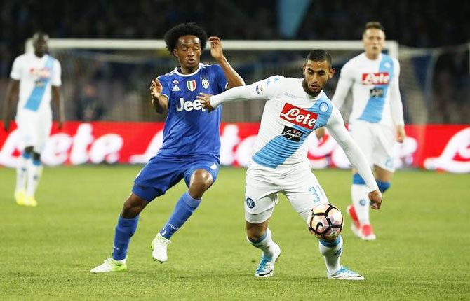Juventus' Juan Cuadrado challenges Napoli's Faouzi Ghoulam as they vie for possession