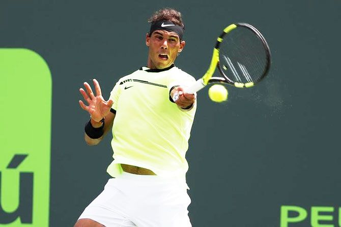Rafael Nadal hits a forehand return against Roger Federer on Sunday