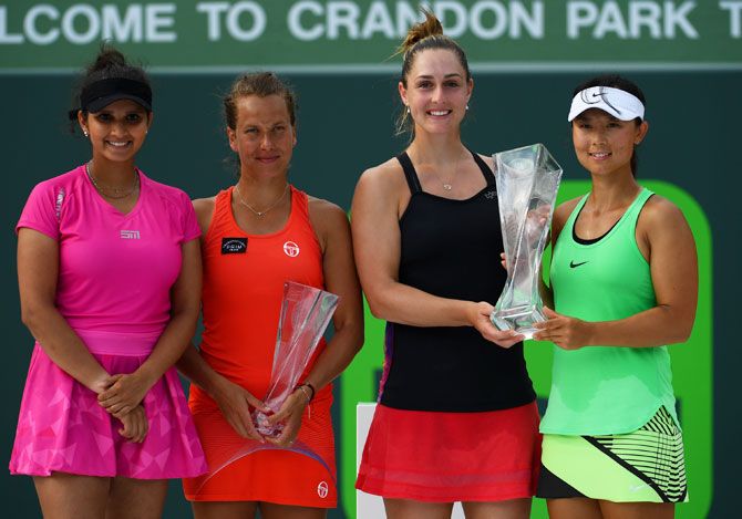 Canada's Gabriela Dabrowski and China's Yifan Xu pose with their trophies alongside runners-up India's Sania Mirza and the Czech Republic's Barbora Strycova, after winning the women's doubles final of the Miami Open at Crandon Park Tennis Center in Key Biscayne, Florida, on Sunday