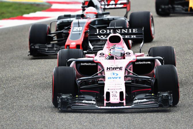 Sergio Perez of Mexico driving the (11) Sahara Force India F1 Team VJM10 leads Kevin Magnussen of Denmark driving the (20) Haas F1 Team Haas-Ferrari VF-17 Ferrari on track during the Formula One Grand Prix of China at Shanghai International Circuit in Shanghai, China, on Sunday