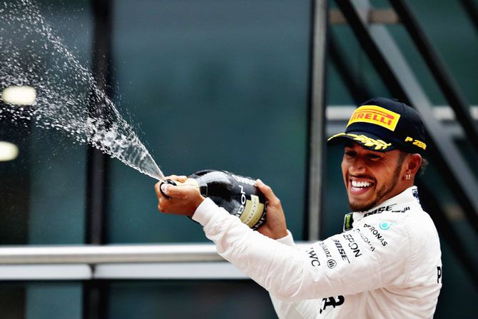 Race winner Lewis Hamilton of Great Britain and Mercedes GP celebrates his win on the podium during the Formula One Grand Prix of China at Shanghai International Circuit in Shanghai, China, on Sunday
