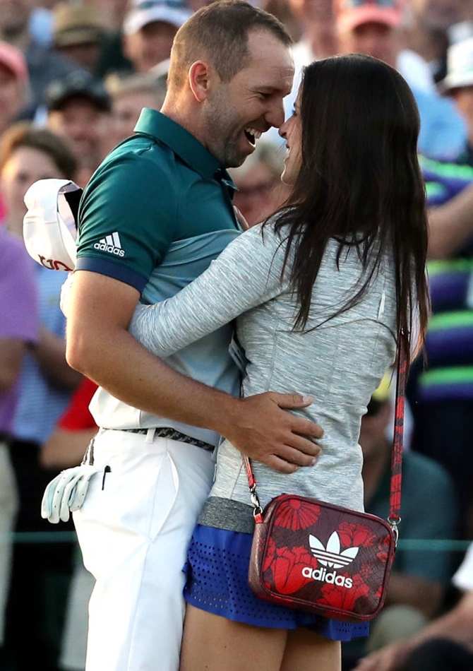 Sergio Garcia of Spain embraces fiancee Angela Akins in celebration after defeating Justin Rose to win the Augusta Masters on Sunday, April 9