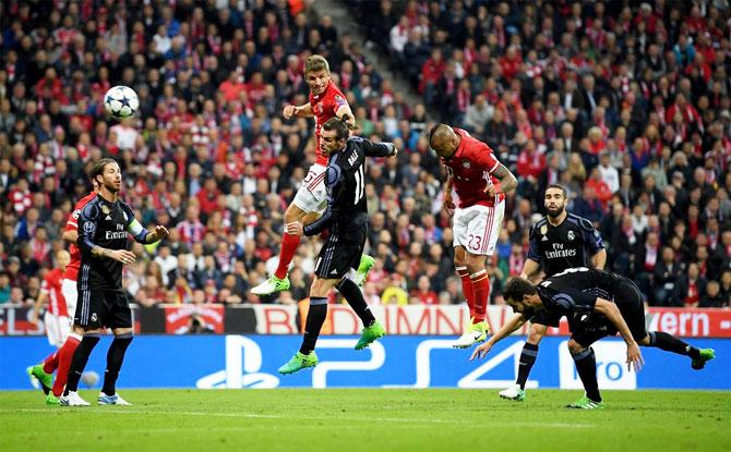 Bayern Munich's Arturo Vidal meets Thiago Alcantara's corner to head in the 25th minute goal against Real Madrid