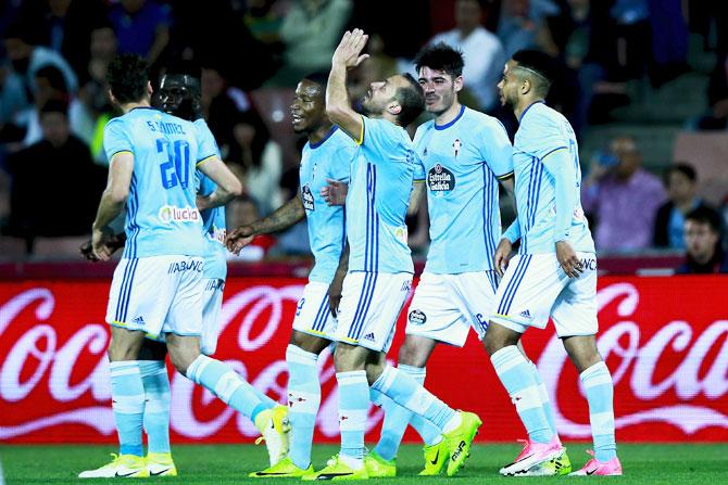 RC Celta de Vigo's Marcelo Diaz (right) celebrates with teammates on scoring their second goal against Granada CF during their La Liga match at Estadio Nuevo Los Carmenes in Granada, Spain, on Sunday