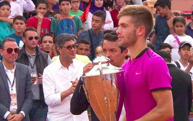 Croatia's Borna Coric poses with the trophy after winning his first ATP title in Marrakech, Morocco, on Sunday
