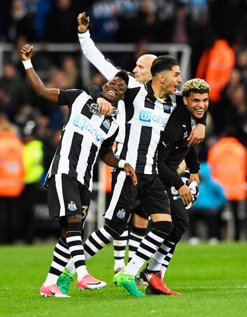 Christian Atsu, Ayoze Perez and DeAndre Yedlin of Newcastle United celebrate victory and promotion