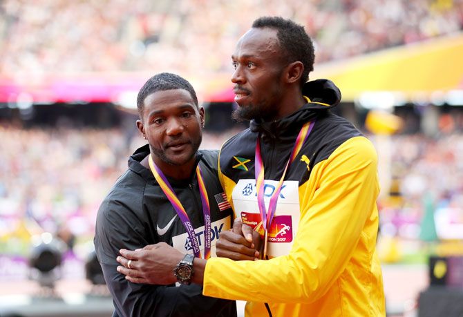 Justin Gatlin of the United States and Usain Bolt of Jamaica embrace during the medal ceremony for the Men's 100 metres final at the 16th IAAF World Athletics Championships at The London Stadium in London, United Kingdom, on Sunday