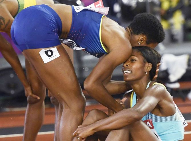 Phyllis Francis (gold) of the US (left) comforts Shaunae Miller-Uibo (4th place) of Bahamas the former won the 400 metres final on Wednesday