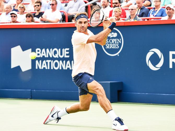 Switzerland's Roger Federer prepares to hit a return against Spain's David Ferrer