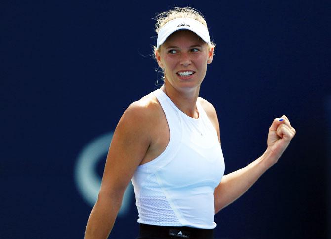 Denmark's Caroline Wozniacki celebrates after defeating Poland's Agnieszka Radwanska