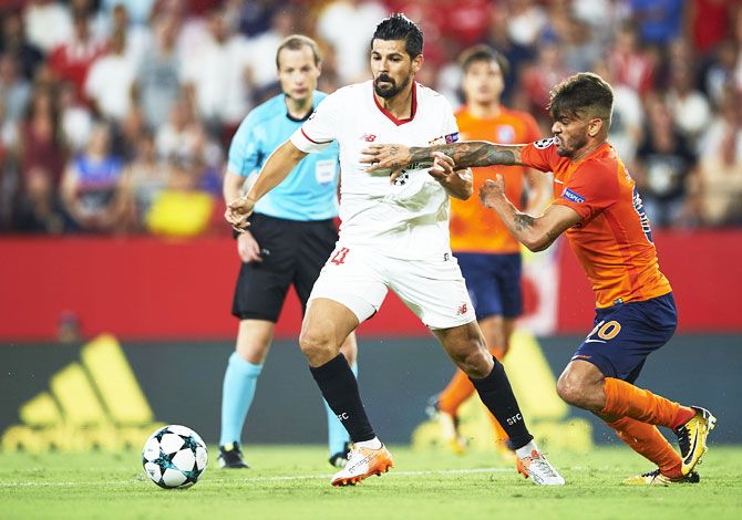 Sevilla FC's Manuel Agudo 'Nolito' (left) competes for the ball with an Istanbul Basaksehi's player during the UEFA Champions League Play-Offs second leg match at Estadio Ramon Sanchez Pizjuan in Seville, Spain, on Tuesday