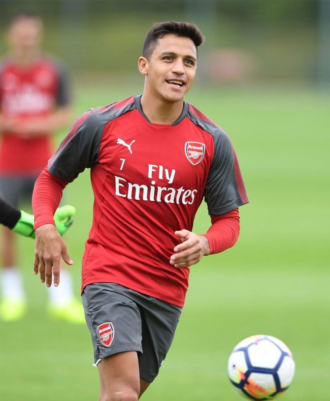 Arsenal's Alexis Sanchez cuts a happy figure during a training session on Thursday