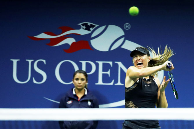 Maria Sharapova in action against Simona Halep in their first round match of the US Open at Flushing Meadows on Monday