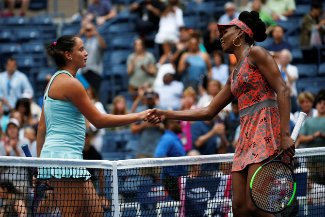 USA's Venus Williams is congratulated by Slovakia's Viktoria Kuzmova after their first round match