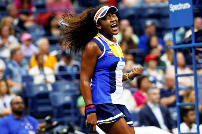 Naomi Osaka reacts after winning a point against Angelique Kerber