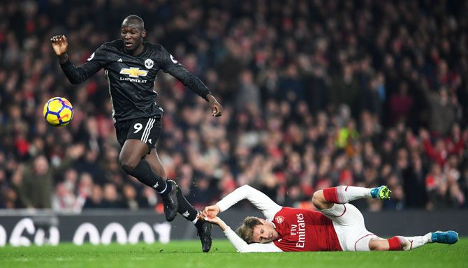 Manchester United's Romelu Lukaku escapes a challenge by Arsenal's Nacho Monreal
