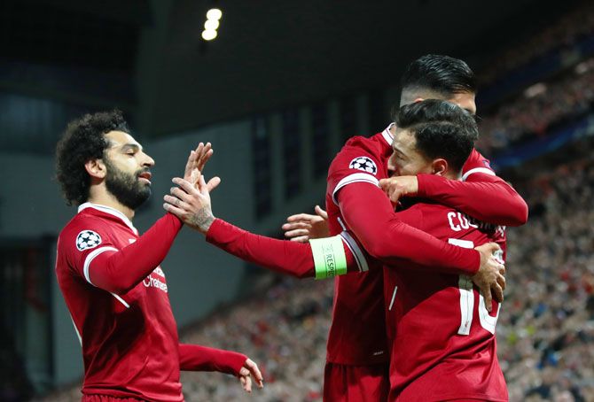 Liverpool's Philippe Coutinho celebrates with teammates Roberto Firmino and Mo Salah during their Group E match against Spartak Moskva at Anfield in Liverpool