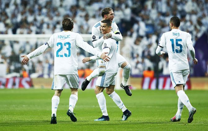 Real Madrid's Cristiano Ronaldo celebrates with teammates after scoring his side's second goal against Borussia Dortmund during their UEFA Champions League Group H match at Estadio Santiago Bernabeu in Madrid on Wednesday