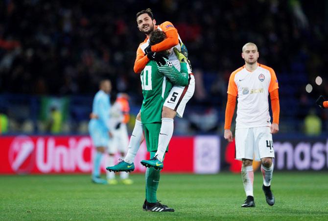 Shakhtar Donetsk's Davit Khocholava celebrates with Andriy Pyatov after defeating Manchester City at Metalist Stadium in Kharkiv, Ukraine