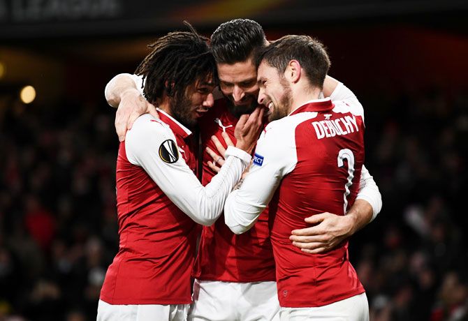 Arsenal's Olivier Giroud celebrates with teammates Mohamed Elneny and Mathieu Debuchy after scoring their fifth goal from the penalty spot against BATE Borisov during their Europa League match at Emirates Stadium in London on Thursday