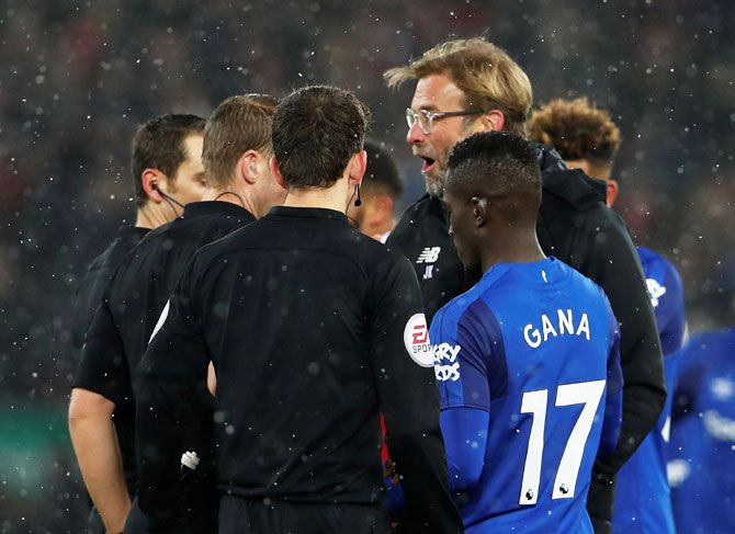 Liverpool manager Juergen Klopp speaks with referee Craig Pawson after the match against Everton at Anfield in Liverpool on Sunday