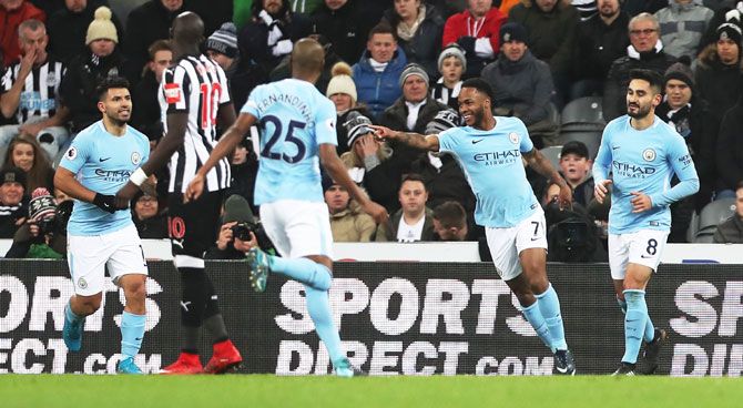 Manchester City's Raheem Sterling celebrates on scoring the opening goal with teammates during the match against Newcastle United at St. James' Park in Newcastle upon Tyne, on Wednesday