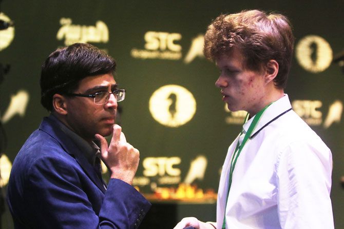 Chess players Vladislav Artemiev (right) and Viswanathan Anand speak on the Day 6 of the King Salman Rapid & Blitz Chess Championships in Riyadh, Saudi Arabia on Saturday