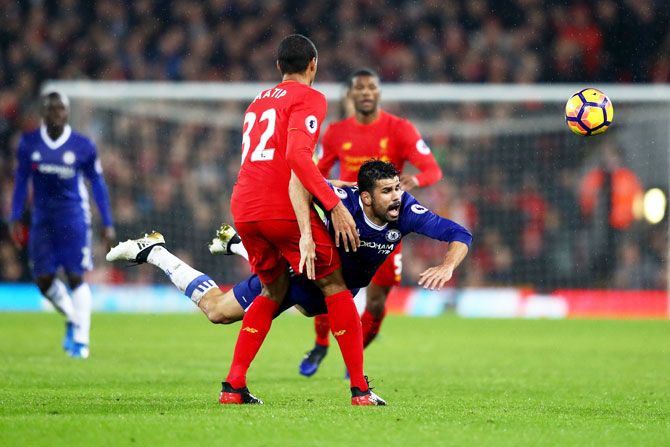 Chelsea's Diego Costa dives in front of Liverpool's Joel Matip as they compete for the ball