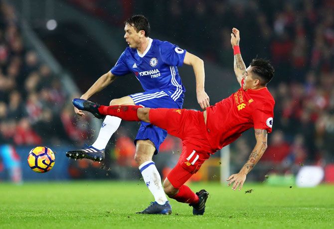 Chelsea's Nemanja Matic and Liverpool's Roberto Firmino vie for the ball during their Premier League at Anfield in Liverpool on Tuesday