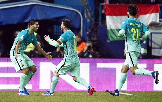 Barcelona's Lionel Messi celebrates with Luis Suarez after scoring their second goal against Atletico Madrid in the first leg semi-final of the King's Cup at Vincente Calderon Stadium in Madrid on Wednesday