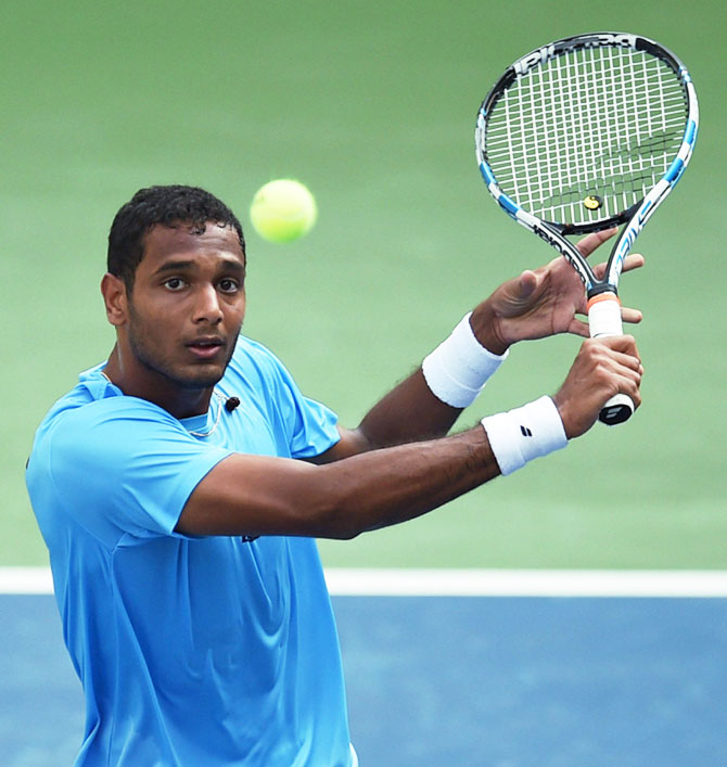 India's Ramkumar Ramanathan plays a return against New Zealand's Finn Tearney during their Davis cup tie in Pune on Sunday