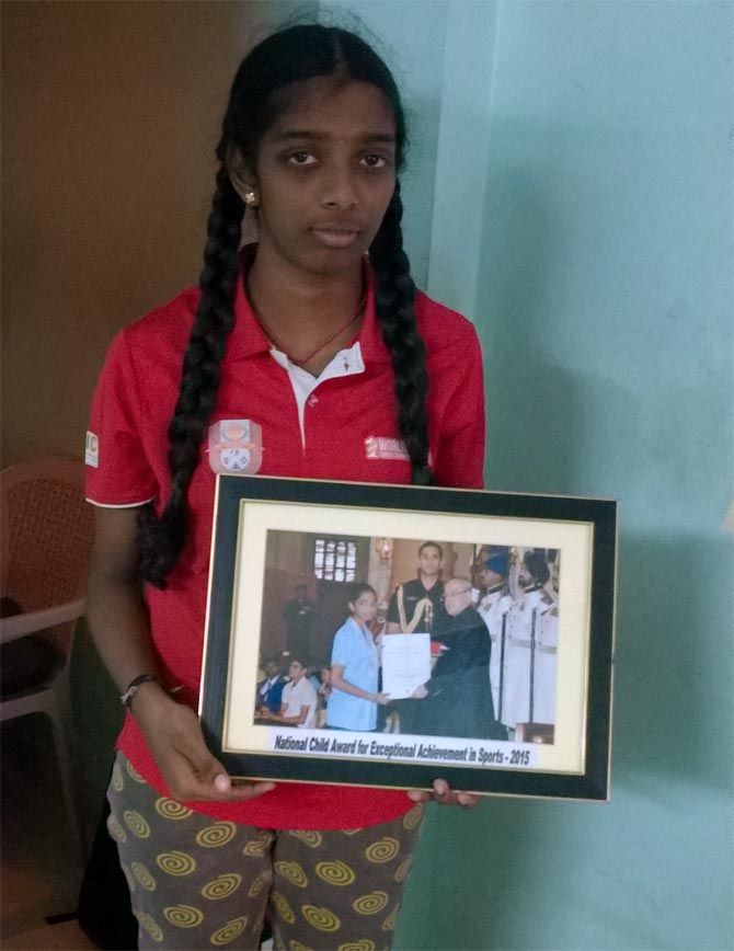 Vaishali with a photograph of her receiving the National Child Award for Exceptional Achievement in Sports - 2015 from President Pranab Mukherjee. Photograph: A Ganesh Nadar/Rediff.com
