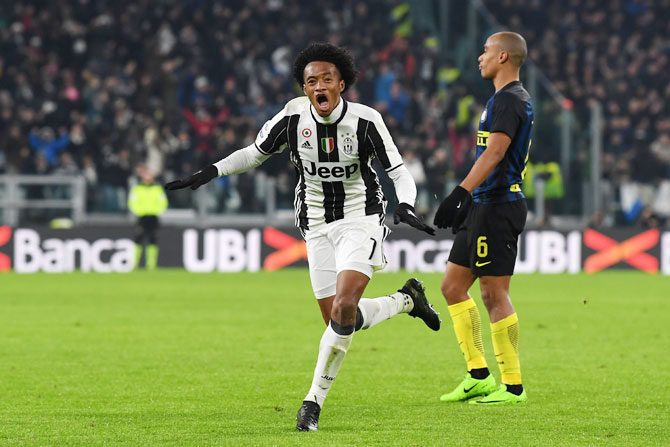 Juventus FC's Juan Cuadrado celebrates after scoring the opening goal against Inter Milan during the Serie A match between at Juventus Stadium in Turin, on Sunday