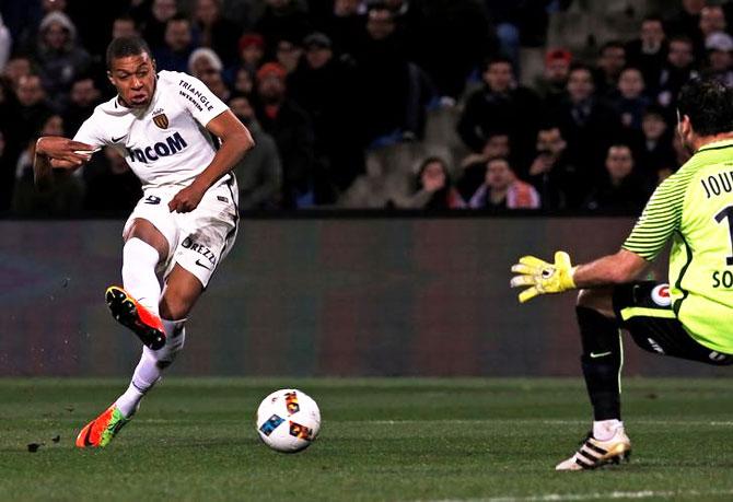 Monaco's Kylian Mbappe Lottin scores past Montpellier's goalkeeper Geoffrey Jourdren during their French Ligue 1 match at Mosson stadium, Montpellier, on Tuesday