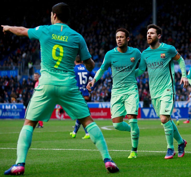 Lionel Messi, Nymar and Luis Suarez celebrate a goal