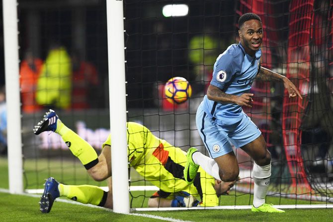 Manchester City's Raheem Sterling wheels away to celebrate after scoring the opening goal past Bournemouth 'keeper Artur Boruc
