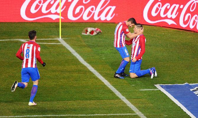 Atletico de Madrid's Fernando Torres celebrates with Koke after scoring his team's opening goal during their La Liga match against RC Celta de Vigo at Vicente Calderon Stadium in Madrid on Sunday